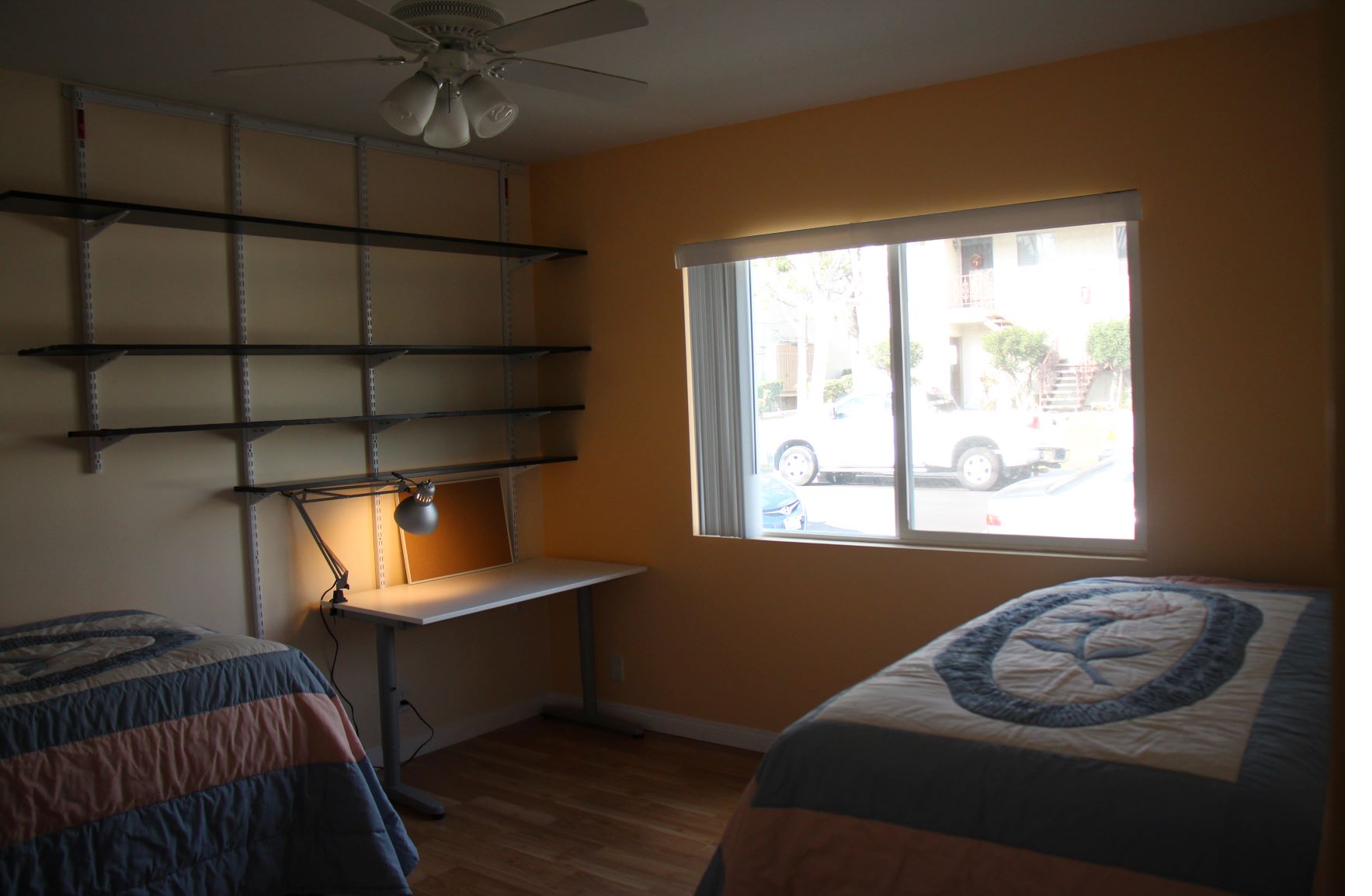 Furnished shared bedroom with dual desks in CSULA student housing