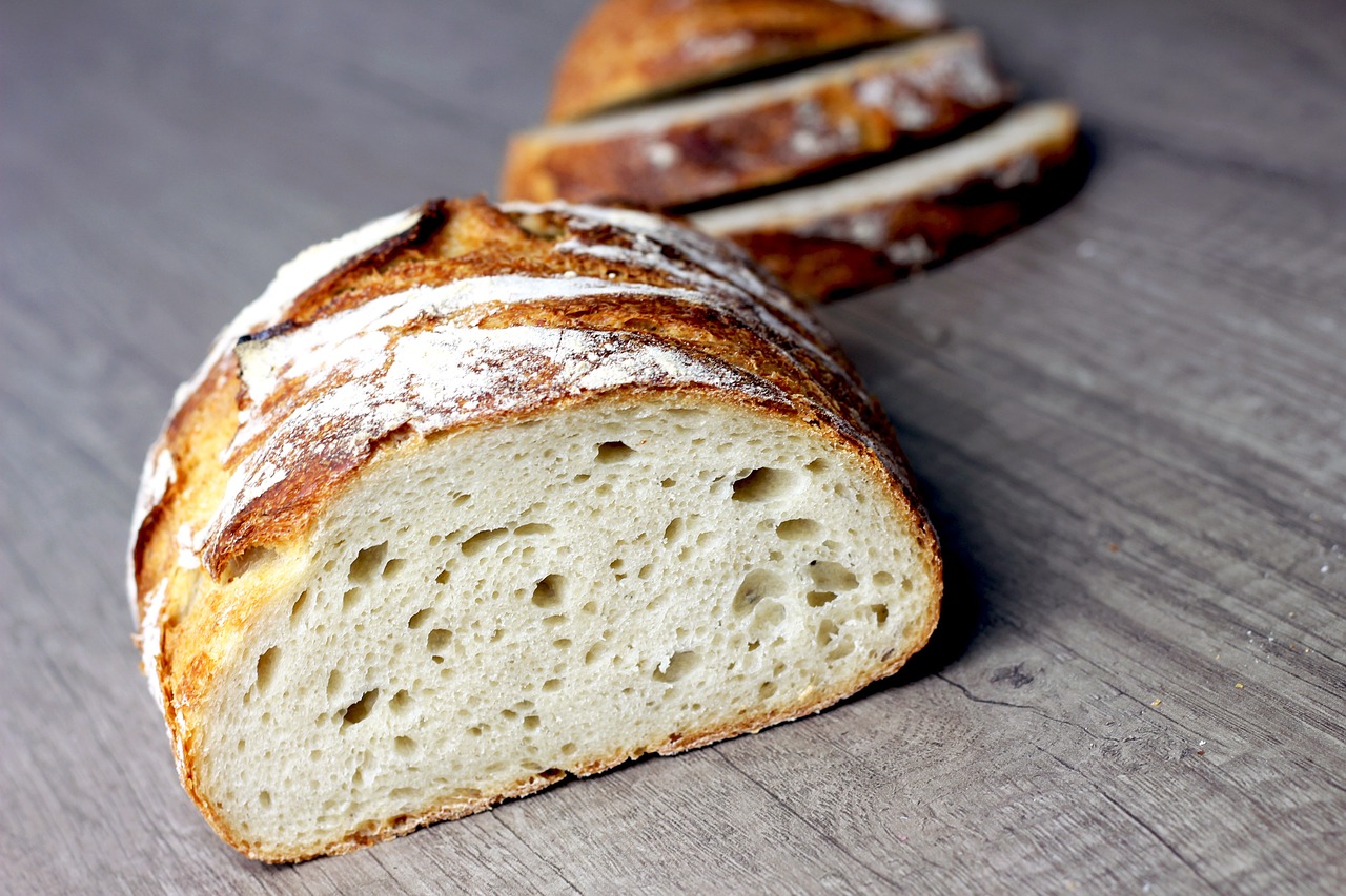 Freshly baked sourdough bread loaf, sliced, with crackled crust
